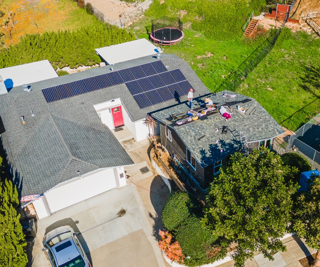 Aerial image of a property with solar panels and ongoing ADU construction, highlighting the benefits of ADUs