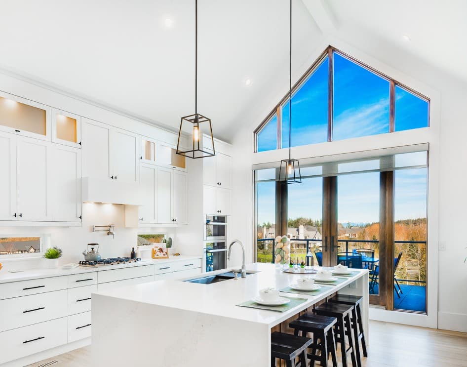 Bright contemporary ADU kitchen with high ceilings, large windows, and modern fixtures.